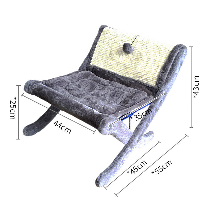 Beige plush cat sofa with a hammock-style seat, wooden frame, and attached hanging toy, placed in a sunlit indoor corner.