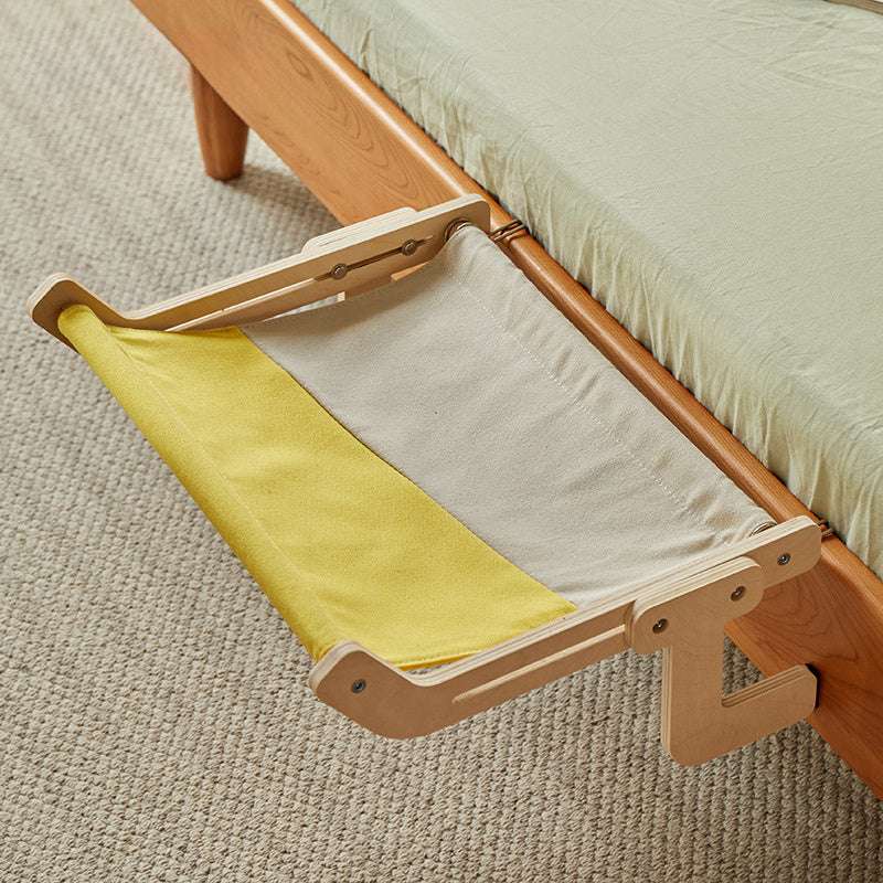 Sunbathing cat on a two-tone hammock designed for windowsills or bedside use.