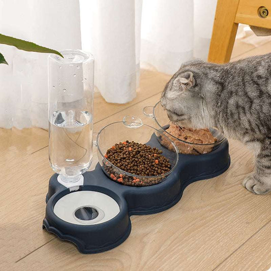 Gray cat eating from dual pet bowls with gravity water dispenser on wooden floor