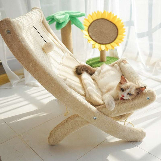 Cat relaxing on a soft, elevated cat chair near a sunny window, surrounded by indoor plants and wooden decor.