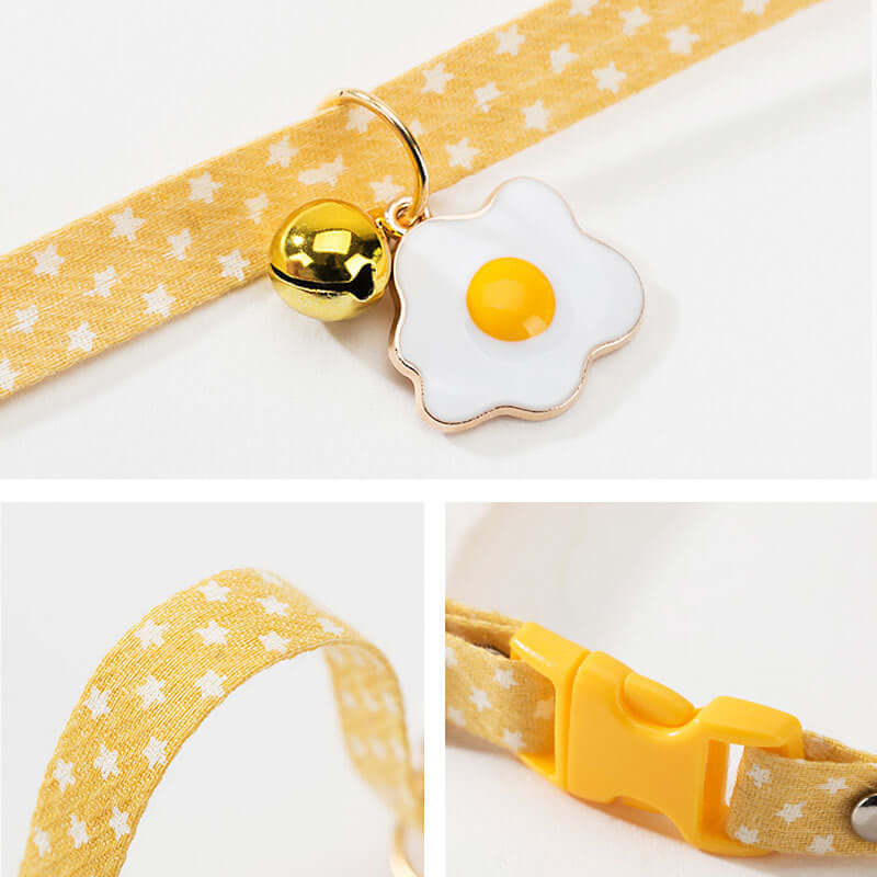 Yellow pet collar with a fried egg-shaped charm on a white background