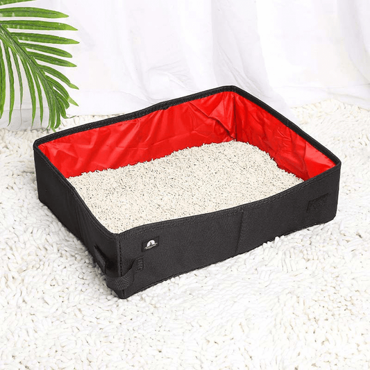 Portable foldable cat litter box with red waterproof interior and black Oxford cloth exterior, filled with litter and placed on a white rug—ideal for travel and home use.
