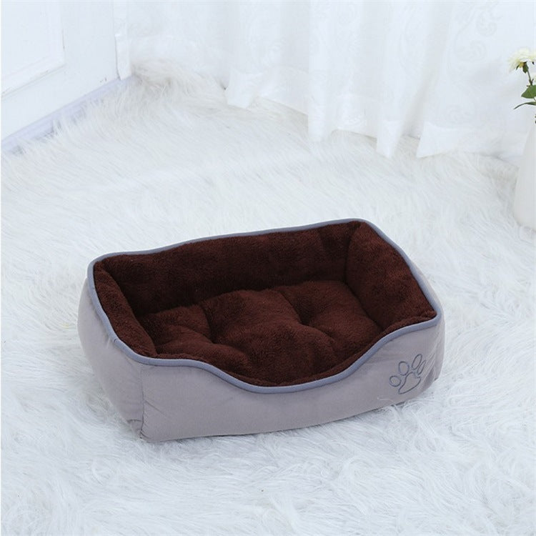 Stylish coffee-tone pet bed with a cozy, padded center, ideal for both cats and small dogs.
