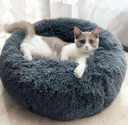 Gray fluffy donut-shaped calming pet bed with a cat resting comfortably