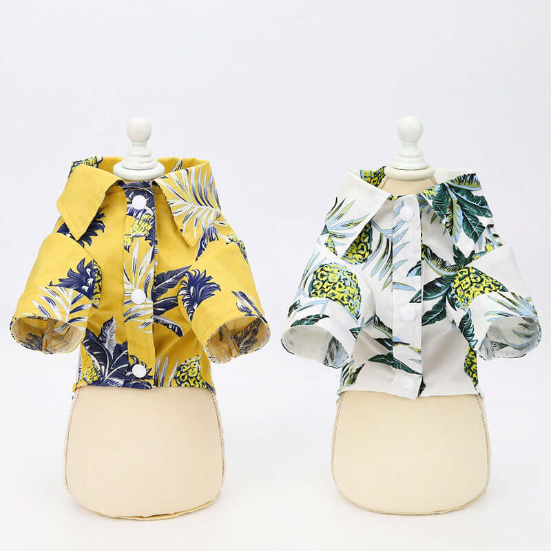 Two mannequin outfits with tropical print jackets on a white background
