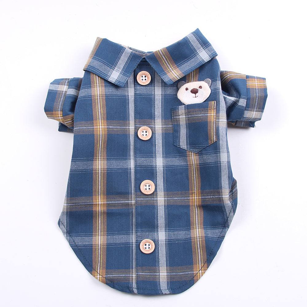 Blue plaid dog shirt with a bear face patch on a white background