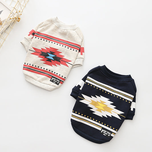 Two dog sweaters with geometric patterns on a white background