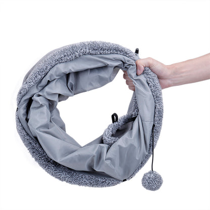 Soft suede cat tunnel stretched out on the floor, perfect for indoor feline playtime.