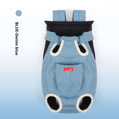 A fluffy cat looks relaxed while sitting in a navy blue pet backpack carrier, surrounded by greenery.