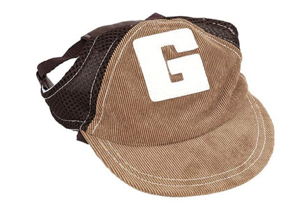 Small to medium dog wearing a woven plain weave corduroy hat indoors
