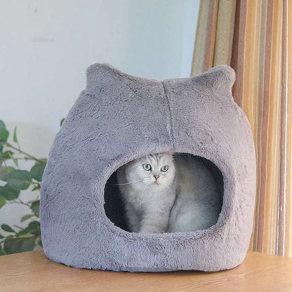 Warm plush cat nest in khaki color placed by window