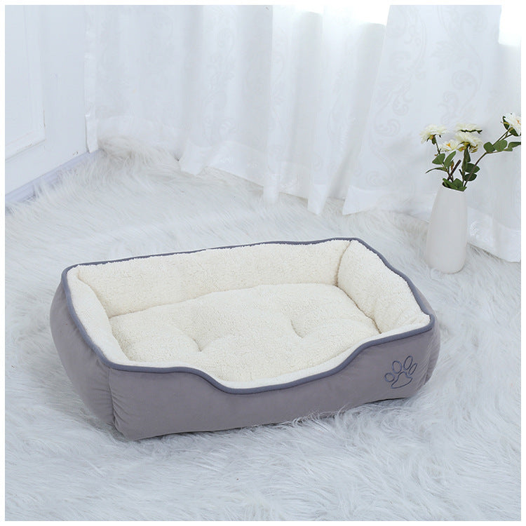Soft white pet bed featuring a tufted center and raised edges for maximum comfort, sitting in a bright, airy room.
