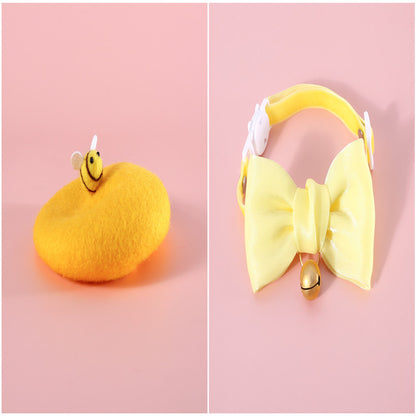 Soft pearl yellow bow with a bell charm, designed to fit comfortably around a cat’s neck for festive flair.