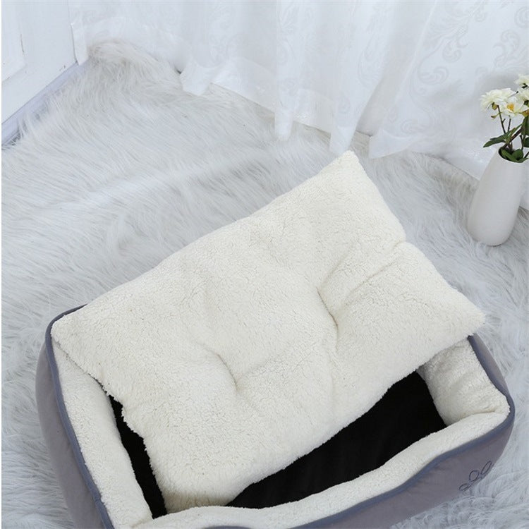 Rectangular white pet bed with cushioned sides and a smooth, elegant design, perfect for small pets.