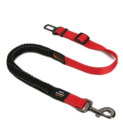 Travel dog seat belt accessory shown attached to harness and car buckle.