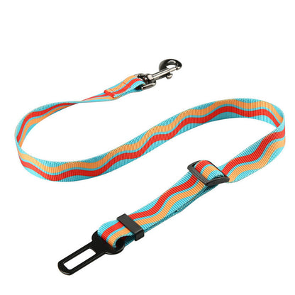 Close-up of dog car restraint strap with metal harness clip.