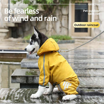 Husky dog wearing a yellow waterproof raincoat sitting near a puddle