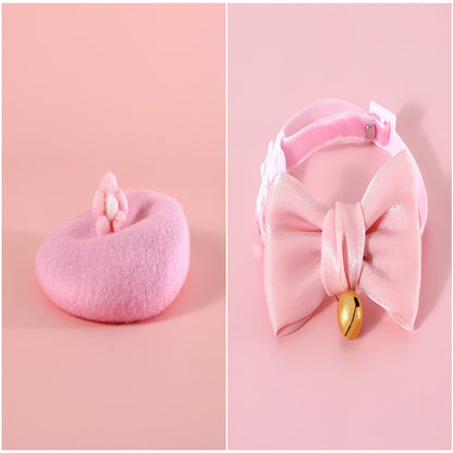 Whimsical pink cat beret featuring small flower accents, styled on a pastel background.